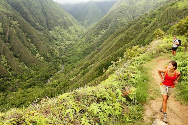 A woman hiking on Waihe’e Ridge Trail.