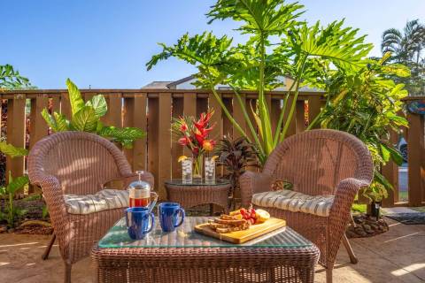 lanai of a maui vacation rental decorated with a beautiful breakfast spread