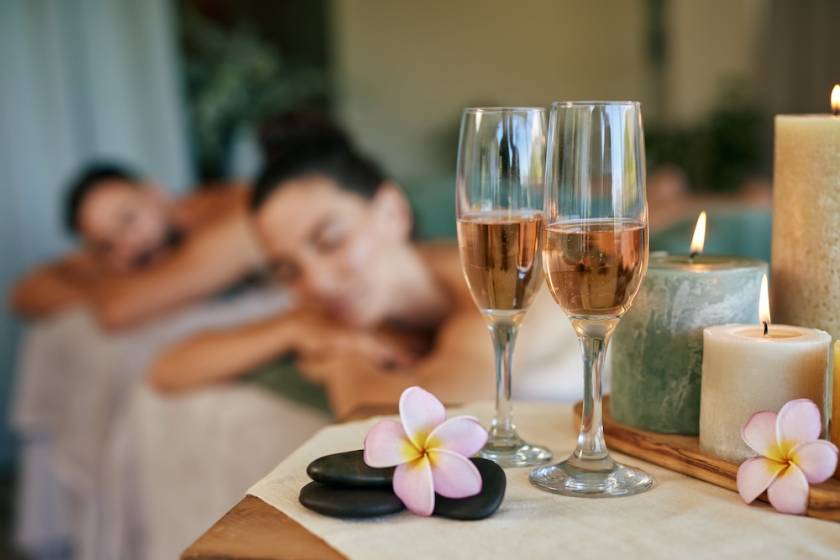 couple's massage in Hawaii with champagne flutes and candles