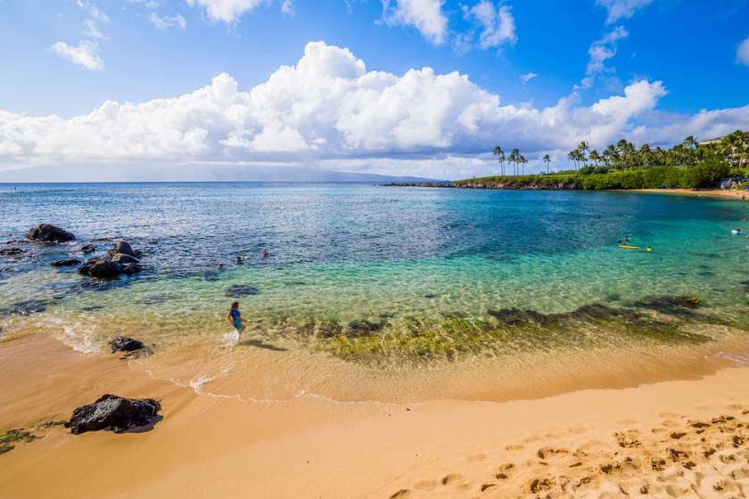 Kapalua Bay maui on a sunny day with snorkelers and swimmers in the water