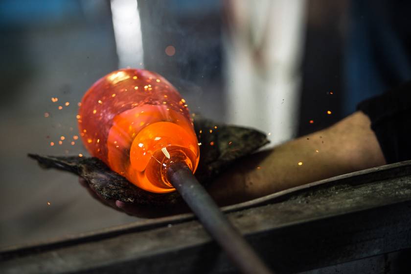 person blowing glass sculpture